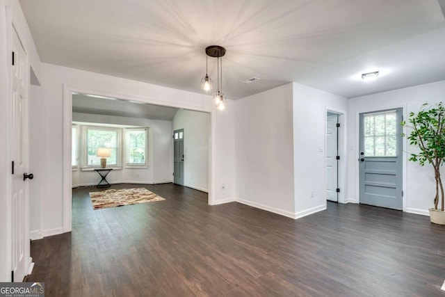 unfurnished room with a wealth of natural light and dark hardwood / wood-style flooring