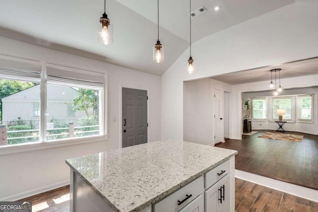 kitchen with a center island, hanging light fixtures, dark wood-type flooring, and white cabinets