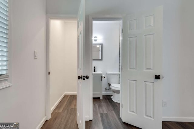 bathroom with wood-type flooring and toilet