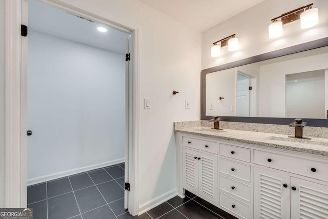 bathroom with dual bowl vanity and tile patterned flooring