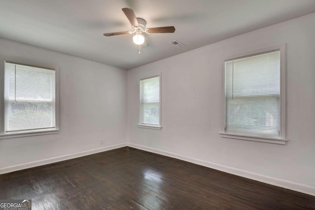 unfurnished room with dark hardwood / wood-style flooring and ceiling fan