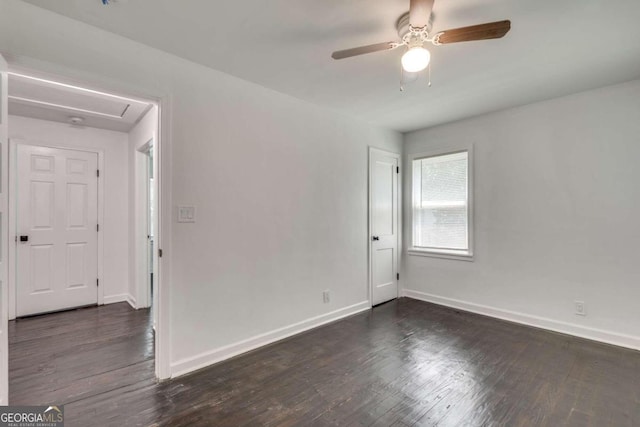 spare room featuring ceiling fan and dark wood-type flooring