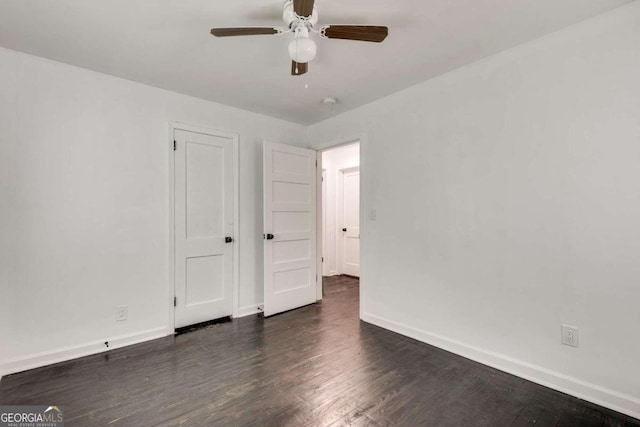 unfurnished bedroom featuring ceiling fan and dark hardwood / wood-style floors