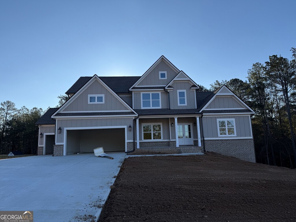 craftsman inspired home with covered porch and a garage