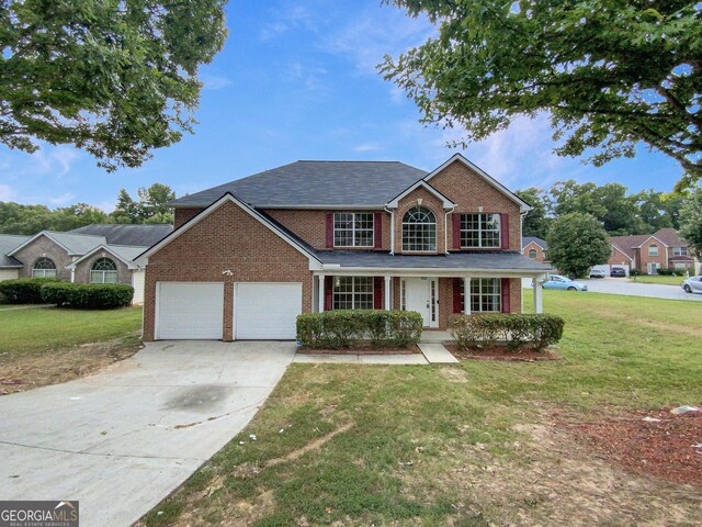 view of front of property featuring a garage and a front yard