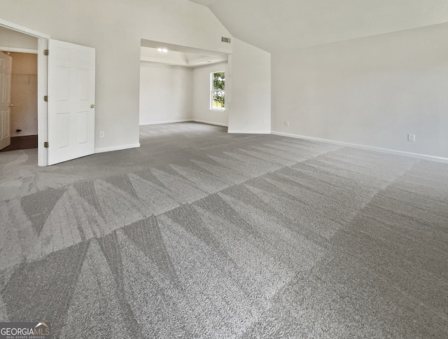 interior space with carpet flooring and vaulted ceiling