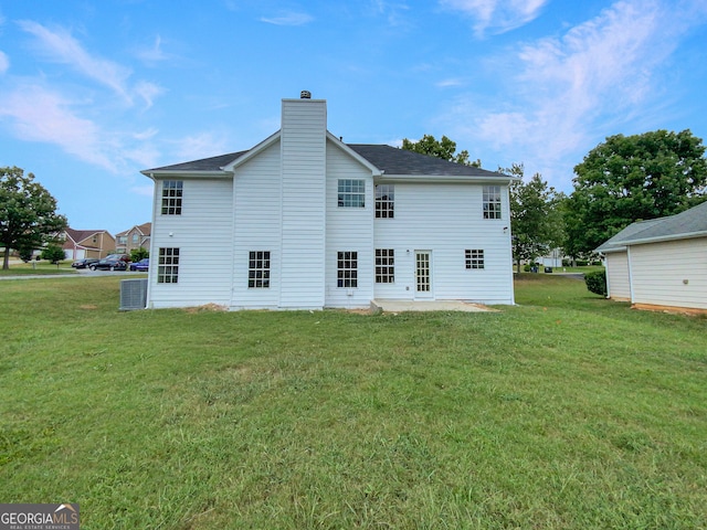 back of house featuring a yard