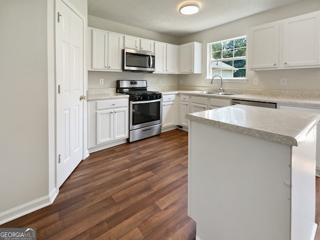 kitchen featuring white cabinetry, appliances with stainless steel finishes, sink, and dark hardwood / wood-style flooring