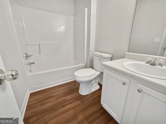 full bathroom featuring toilet, washtub / shower combination, vanity, and wood-type flooring