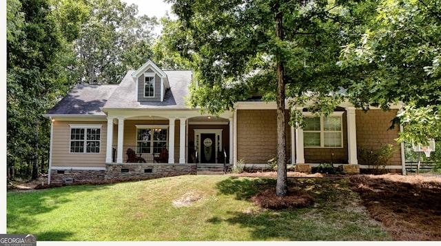 cape cod house featuring a porch and a front yard