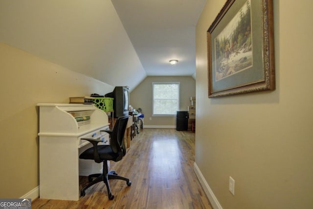 office area featuring wood-type flooring and lofted ceiling