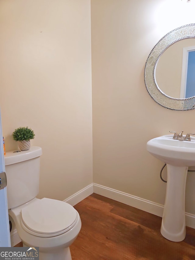 bathroom featuring toilet and hardwood / wood-style flooring