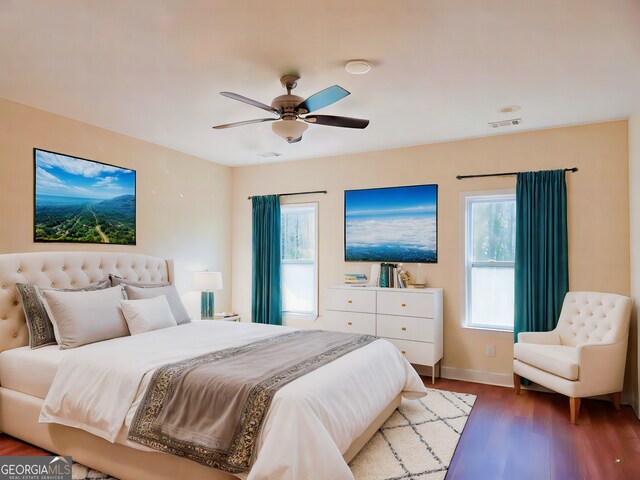 bedroom featuring ceiling fan and dark hardwood / wood-style floors