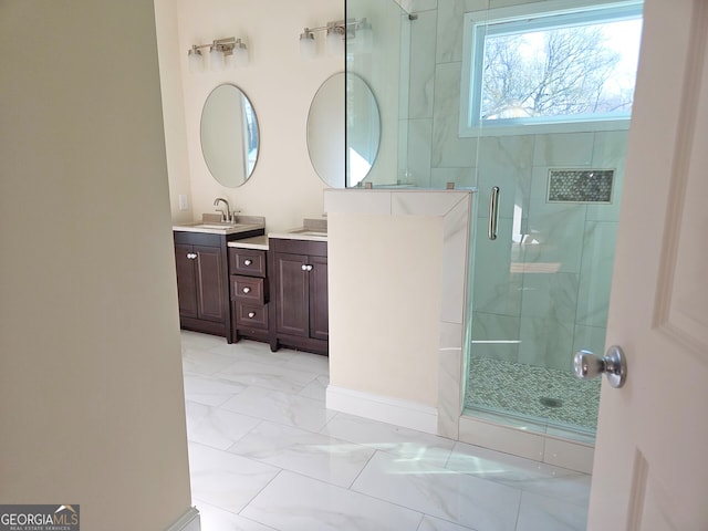 bathroom featuring vanity, a shower stall, and marble finish floor