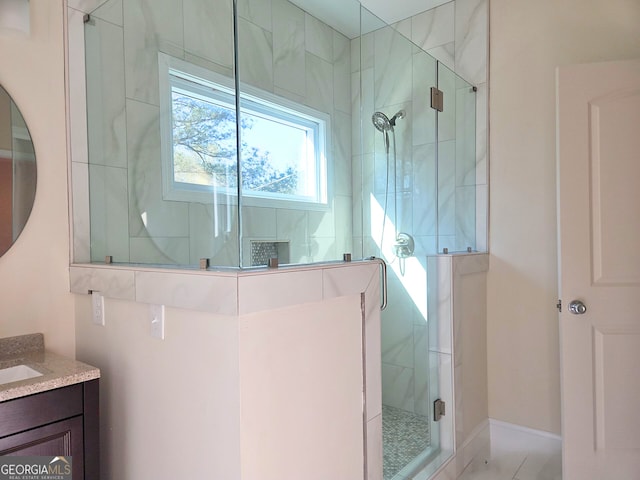 bathroom featuring vanity and a shower stall