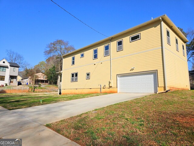 view of property exterior with a garage and a lawn