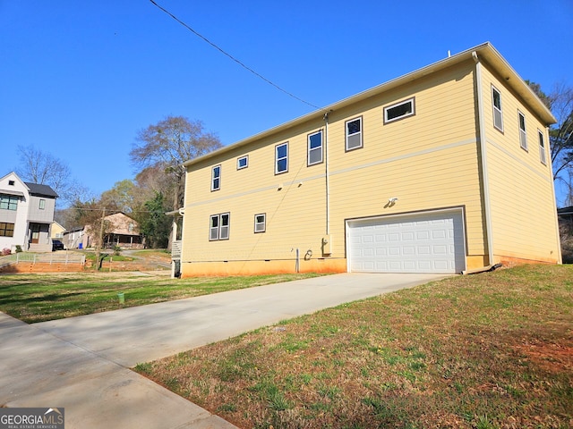 view of property exterior featuring a lawn, concrete driveway, and a garage