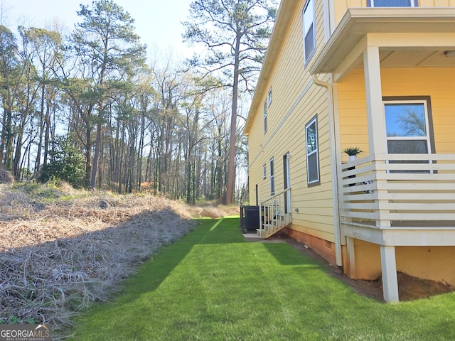 view of home's exterior with central air condition unit, a lawn, and entry steps