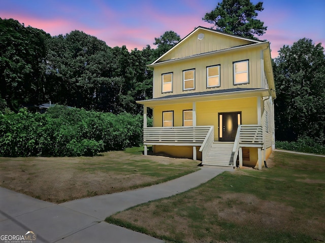 view of front of home with a yard and covered porch