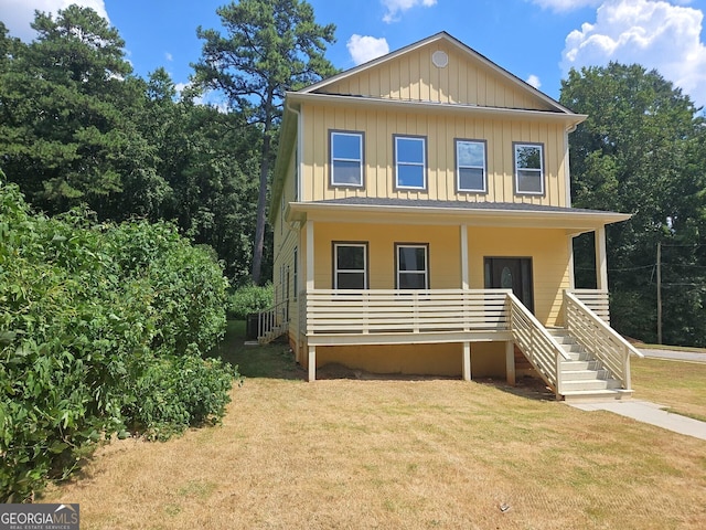 front facade featuring a porch and a front lawn