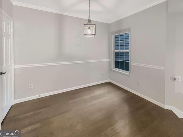 spare room with baseboards, dark wood-type flooring, and ornamental molding