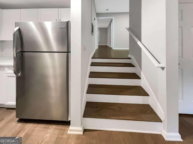 staircase featuring hardwood / wood-style floors