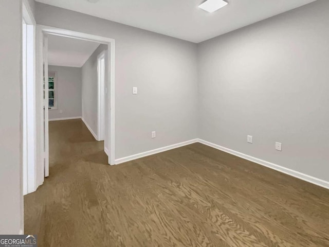 spare room featuring dark wood-type flooring