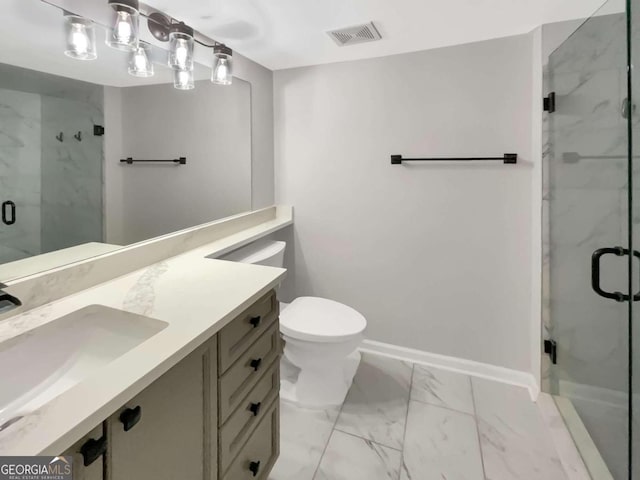 bathroom with tile patterned floors, a shower with shower door, vanity, and toilet