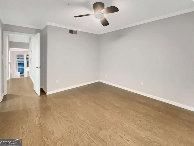 empty room with ceiling fan, wood-type flooring, and ornamental molding