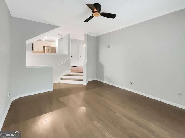 unfurnished living room featuring hardwood / wood-style flooring and ceiling fan