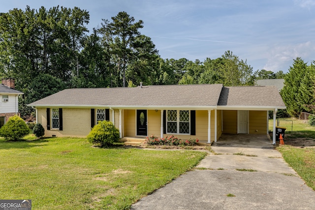 ranch-style house featuring a front lawn and a carport