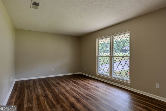 empty room featuring hardwood / wood-style floors and a textured ceiling