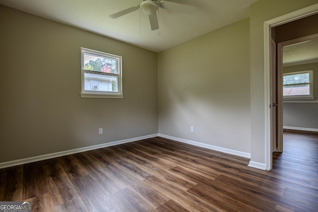 spare room featuring ceiling fan and dark hardwood / wood-style floors