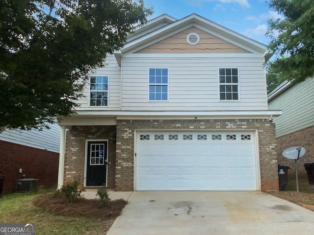 view of front of house with a garage and cooling unit