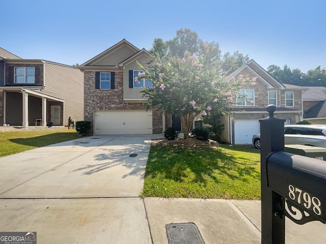 view of front facade featuring a garage, a front yard, concrete driveway, and brick siding