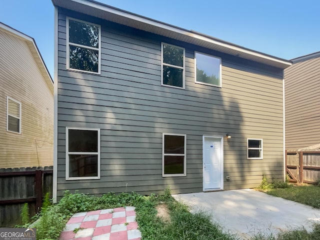 back of house with a patio and fence