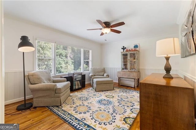 sitting room with ceiling fan, light hardwood / wood-style flooring, and ornamental molding