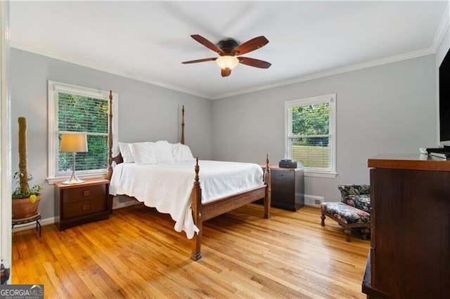 bedroom with light hardwood / wood-style floors, ornamental molding, and ceiling fan