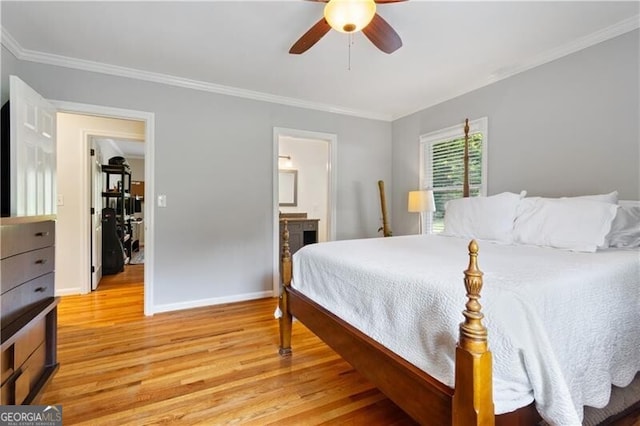 bedroom featuring ceiling fan, light hardwood / wood-style floors, ornamental molding, and ensuite bath