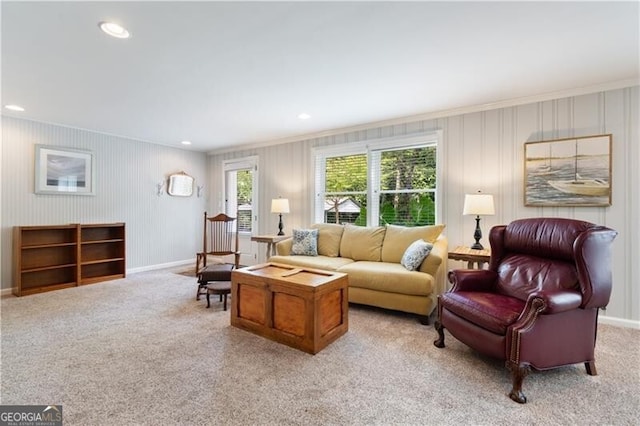 living room with crown molding and light colored carpet