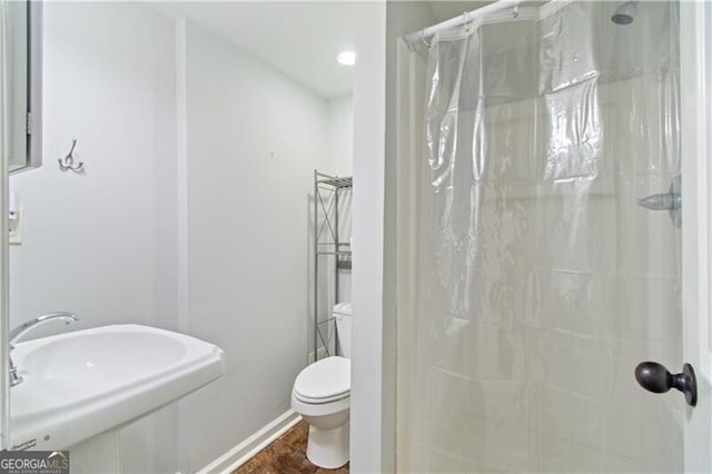 bathroom with sink, toilet, curtained shower, and tile patterned floors