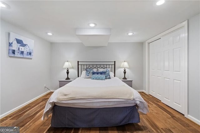 bedroom with wood-type flooring and a closet