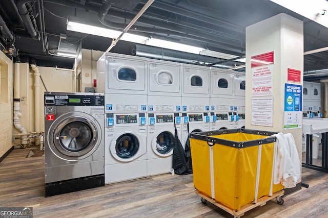 washroom featuring stacked washer and clothes dryer, wood-type flooring, and independent washer and dryer