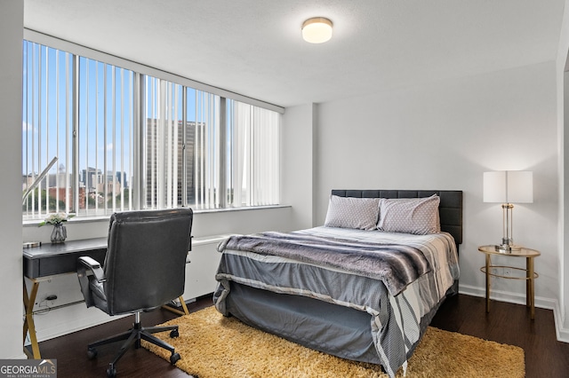 bedroom with dark hardwood / wood-style floors