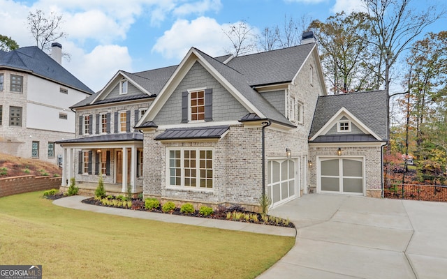 view of front of property with a front lawn, covered porch, and a garage