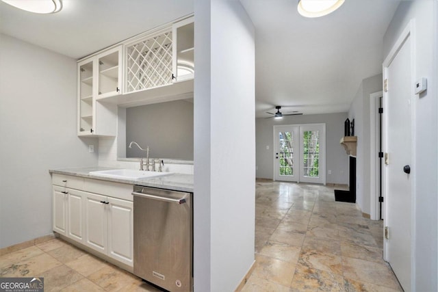 kitchen with dishwasher, sink, light stone counters, ceiling fan, and light tile patterned flooring