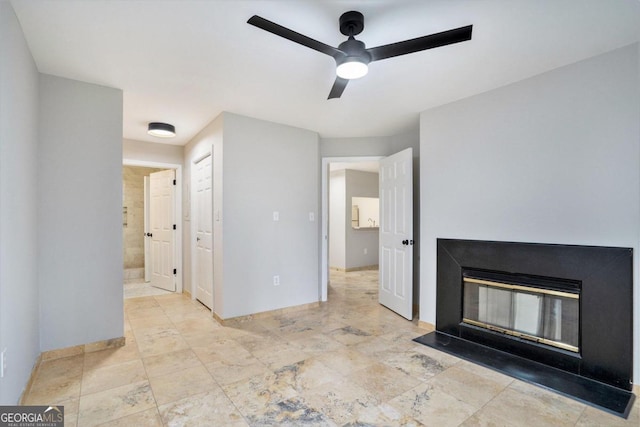 unfurnished living room with ceiling fan and light tile patterned flooring