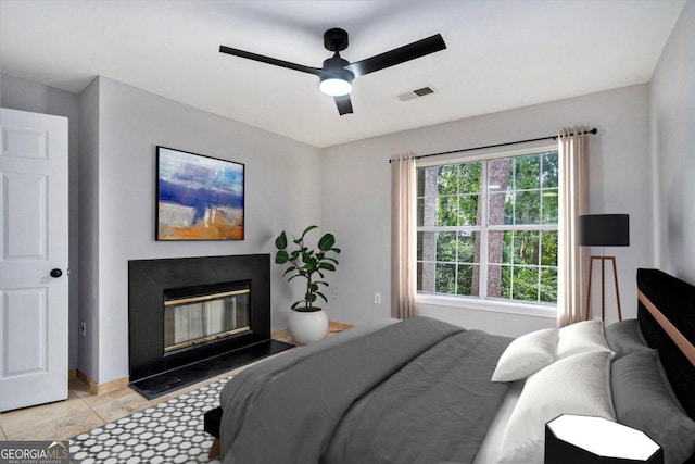 tiled bedroom with ceiling fan