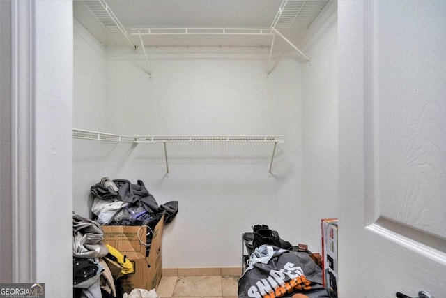 walk in closet featuring light tile patterned flooring