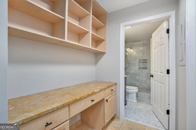 bathroom featuring toilet, an enclosed shower, tile patterned floors, and vanity